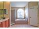 Bathroom featuring a large tub under an arch window, separate shower and vanity with wooden cabinets at 12286 23Rd E St, Parrish, FL 34219