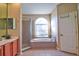 Bright bathroom features a glass shower, soaking tub, and an arched window for natural light at 12286 23Rd E St, Parrish, FL 34219