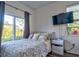 Bedroom with a sliding glass door to the backyard and a mounted TV for entertainment at 12286 23Rd E St, Parrish, FL 34219