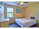 Bedroom featuring a window with natural light, wood floors, and neutral walls, creating a cozy ambiance at 12286 23Rd E St, Parrish, FL 34219