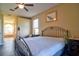 Bedroom featuring neutral walls, wood floors, and a king bed with a decorative wrought iron headboard at 12286 23Rd E St, Parrish, FL 34219