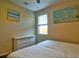 Bedroom with a white dresser next to a bed and a window offering natural light at 12286 23Rd E St, Parrish, FL 34219