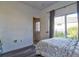 Bright bedroom featuring a bed, sliding glass door, and neutral decor at 12286 23Rd E St, Parrish, FL 34219