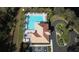 Overhead view displays a community pool, palm trees, lounge area, and manicured landscaping at 12286 23Rd E St, Parrish, FL 34219