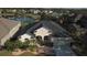 An aerial view of the home highlighting the manicured landscaping, two car garage, and well-maintained roof at 12286 23Rd E St, Parrish, FL 34219