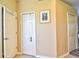 Neutral hallway with multiple doors and a decorative picture on the wall at 12286 23Rd E St, Parrish, FL 34219