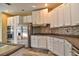 Gourmet kitchen boasts stainless steel appliances, tiled backsplash, and sleek countertops at 12286 23Rd E St, Parrish, FL 34219
