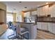 Open kitchen with breakfast bar, stainless steel appliances, and a tile backsplash at 12286 23Rd E St, Parrish, FL 34219