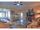 Cozy living room featuring tile floors, furniture, decor, and access to patio at 12286 23Rd E St, Parrish, FL 34219