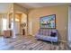 Open living room with a futon, tile floors, front door and coat rack at 12286 23Rd E St, Parrish, FL 34219