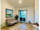 Cozy living room with a futon, tile floors, and sliding glass doors to the patio at 12286 23Rd E St, Parrish, FL 34219