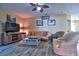 Relaxing living room showcasing tile floors, a ceiling fan and a decorative fireplace at 12286 23Rd E St, Parrish, FL 34219