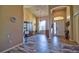 Open living room with tile floors, chandelier, display cabinet and front door entryway at 12286 23Rd E St, Parrish, FL 34219