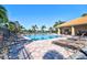 Community pool with ample seating and lush palm trees, perfect for relaxation at 12286 23Rd E St, Parrish, FL 34219