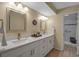 Well-lit bathroom with double vanity, quartz countertops, modern fixtures, and tiled shower at 14 Tidy Island Blvd, Bradenton, FL 34210