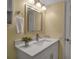 Bathroom vanity featuring white cabinetry, quartz countertops, and updated fixtures at 14 Tidy Island Blvd, Bradenton, FL 34210