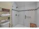 Modern shower with glass door, white tile, mosaic accent, and a built-in bench at 14 Tidy Island Blvd, Bradenton, FL 34210