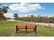 A serene view of the river with a bench overlooking the water at 14912 Sora Way, Bradenton, FL 34212