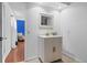 Well-lit bathroom showcasing a modern vanity and doorway to another room at 1510 Lena Ln, Sarasota, FL 34240