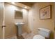 Traditional half bathroom with a pedestal sink, framed mirror, and tile flooring at 1510 Lena Ln, Sarasota, FL 34240