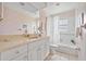 Bright bathroom features a bathtub with shower, toilet, and vanity with sink at 1510 Lena Ln, Sarasota, FL 34240