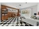 Bedroom boasts sliding glass doors to pool, and fun black and white flooring at 1510 Lena Ln, Sarasota, FL 34240