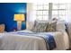Comfortable bedroom featuring a white bedspread, decorative pillows, and bright natural light from the window at 1510 Lena Ln, Sarasota, FL 34240