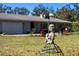 Charming single-story home with a well-manicured lawn and delightful garden statue at 1510 Lena Ln, Sarasota, FL 34240
