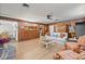 Enjoy this comfortable living room with wood paneling and charming decor at 1510 Lena Ln, Sarasota, FL 34240
