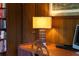 Home office close-up showcasing a desk, table lamp, and wood paneled walls at 1510 Lena Ln, Sarasota, FL 34240