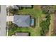 Aerial view of house with a screened in pool, gray roof and well maintained lawn at 16422 Rivers Reach Blvd, Parrish, FL 34219