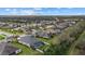 Aerial view showcases backyard pool, neat landscaping, and neighborhood pond at 16422 Rivers Reach Blvd, Parrish, FL 34219