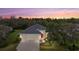 Aerial twilight shot of a well-maintained home with an expansive treeline in the background at 16422 Rivers Reach Blvd, Parrish, FL 34219