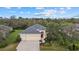 Stunning aerial view of a single-Gathering home showcasing its manicured lawn and landscape at 16422 Rivers Reach Blvd, Parrish, FL 34219