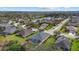 Aerial view of a home with a screened-in pool and lush surroundings in a serene neighborhood at 16422 Rivers Reach Blvd, Parrish, FL 34219