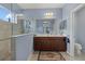Well-lit bathroom featuring a double sink vanity, a glass-enclosed shower, and modern fixtures at 16422 Rivers Reach Blvd, Parrish, FL 34219