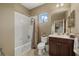 Well-lit bathroom with a shower-tub combo and a single sink vanity at 16422 Rivers Reach Blvd, Parrish, FL 34219