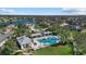 Community pool with outdoor seating, lake view, and lush landscaping creates a relaxing atmosphere at 16422 Rivers Reach Blvd, Parrish, FL 34219