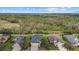 An elevated exterior view of the home showing a large green wooded area in the background at 16422 Rivers Reach Blvd, Parrish, FL 34219