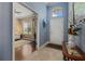 Inviting foyer with tile flooring, high ceilings, and a glimpse into the adjacent living room at 16422 Rivers Reach Blvd, Parrish, FL 34219