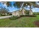 A cozy single Gathering home featuring an attached three car garage and verdant landscaping surrounding the property at 16422 Rivers Reach Blvd, Parrish, FL 34219