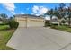 Spacious three-car garage home with well-manicured lawn and landscaping at 16422 Rivers Reach Blvd, Parrish, FL 34219