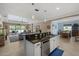 Spacious kitchen with island seating, overlooking the living room and outdoor patio at 16422 Rivers Reach Blvd, Parrish, FL 34219