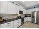 Kitchen with stainless steel appliances and stone countertops at 16422 Rivers Reach Blvd, Parrish, FL 34219