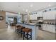 Kitchen with white cabinets, stainless steel appliances, and barstool seating at the island at 16422 Rivers Reach Blvd, Parrish, FL 34219