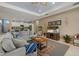 Spacious living room with a large sectional sofa, view of aquarium, and entertainment center at 16422 Rivers Reach Blvd, Parrish, FL 34219