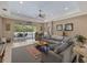 Spacious living room with a large sectional couch and outdoor patio access at 16422 Rivers Reach Blvd, Parrish, FL 34219