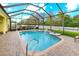 A lovely screened-in pool with brick pavers and a waterfall feature is surrounded by lush landscaping at 16422 Rivers Reach Blvd, Parrish, FL 34219