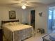 Bright bedroom featuring neutral tones, tiled floors, a ceiling fan, and an ensuite bathroom at 2216 Huntington Ave, Sarasota, FL 34232