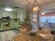 Bright kitchen with vintage oven, light green cabinets, and an open view to the dining and living areas at 2216 Huntington Ave, Sarasota, FL 34232